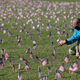 Chris Duncan, whose 75-year-old mother Constance died from the viral illness, photographs a COVID Memorial Project installation of 20,000 American flags meant to mourn the then 200,000 U.S. lives lost in the pandemic on September 22, 2020 in Washington, DC